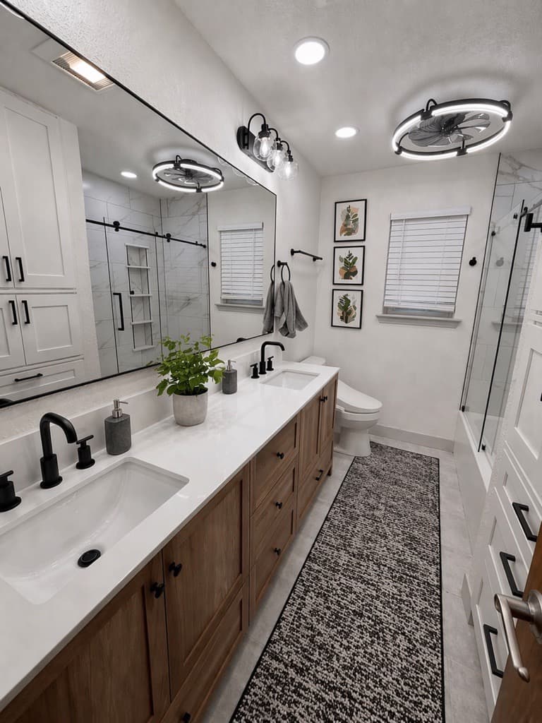 Modern bathroom with wood double vanity, black fixtures, patterned runner rug, and glass shower.