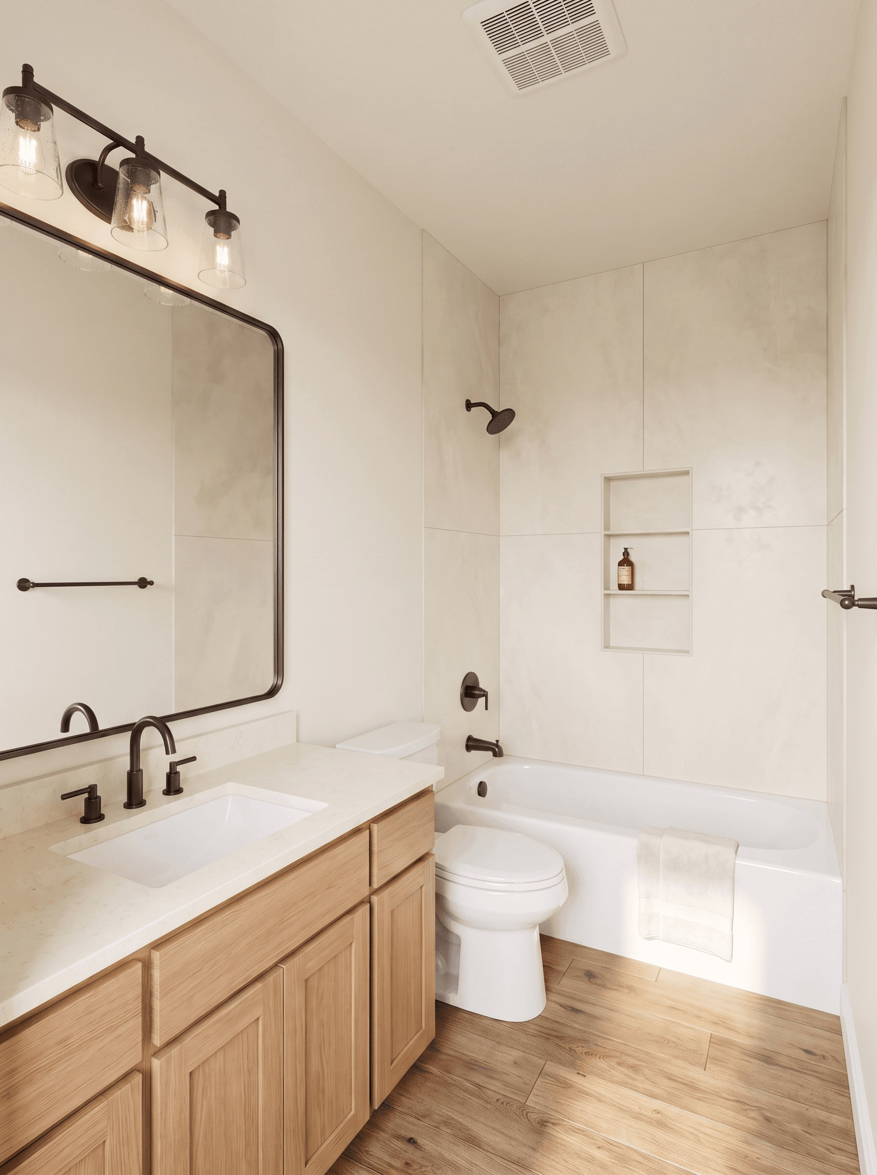 Modern bathroom featuring light wood vanity, white bathtub, and dark bronze fixtures throughout.